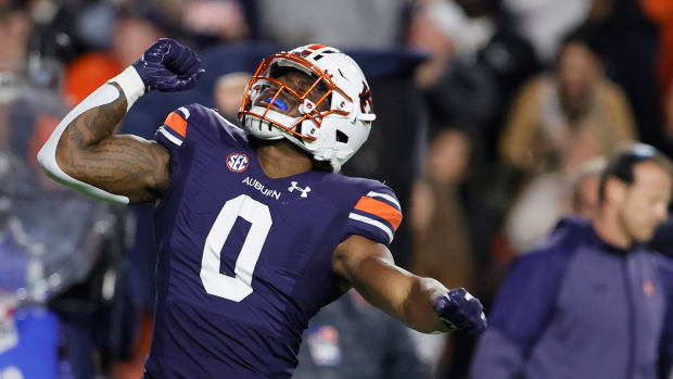 Oct 30, 2021; Auburn, Alabama, USA; Auburn Tigers linebacker Owen Pappoe (0) celebrates after a tackle for a loss against the Mississippi Rebels during the first quarter at Jordan-Hare Stadium. Mandatory Credit: John Reed-USA TODAY Sports